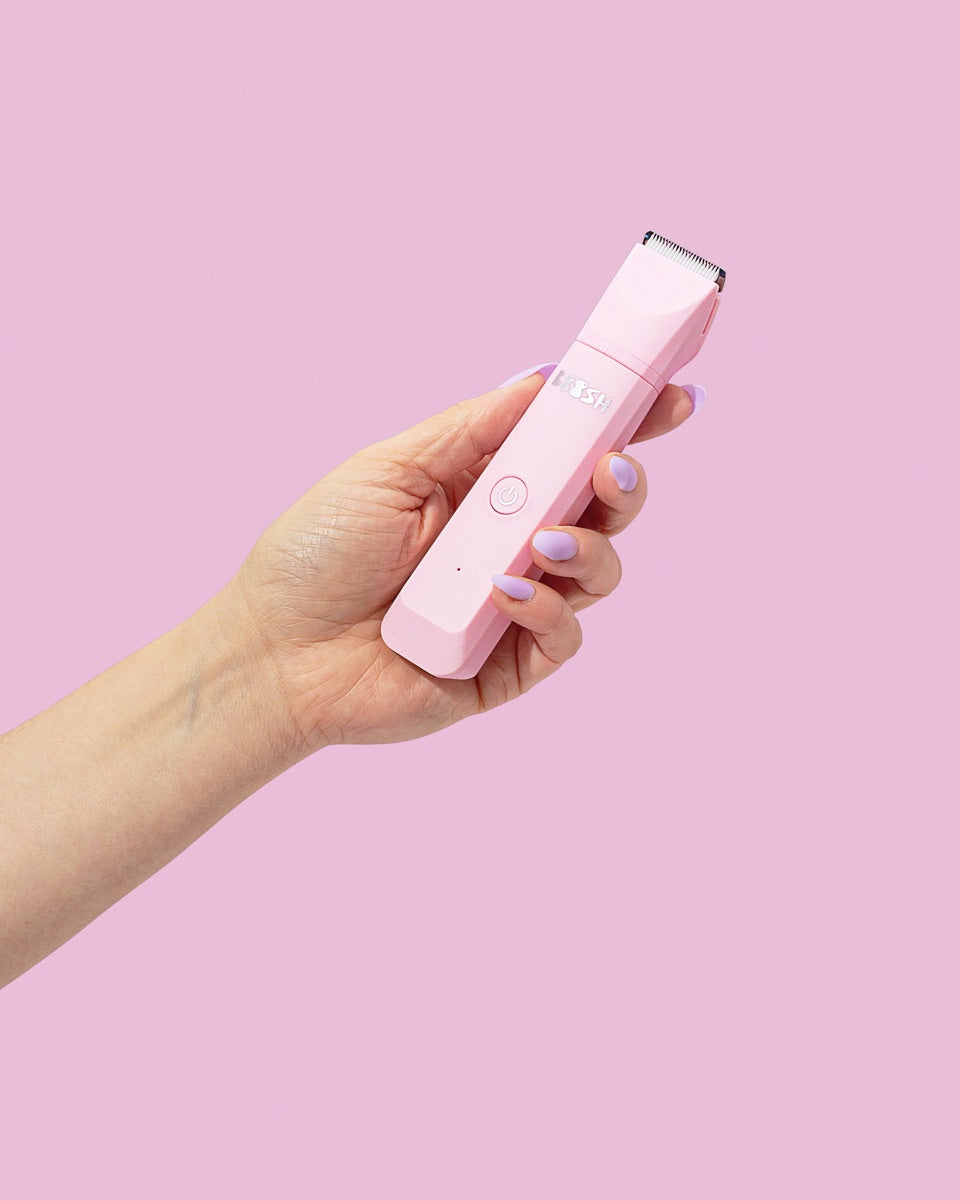 Boosh trimmer held in one hand, to show its size